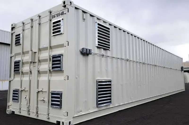 White sea container with side ventilation grilles.