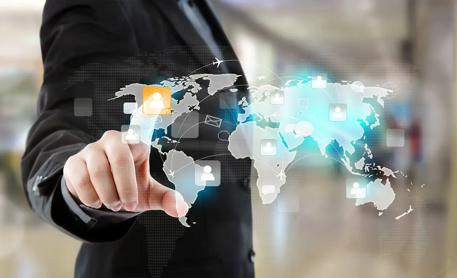 Professional in a suit interacting with a digital world map interface showing global logistics networks and communication icons.