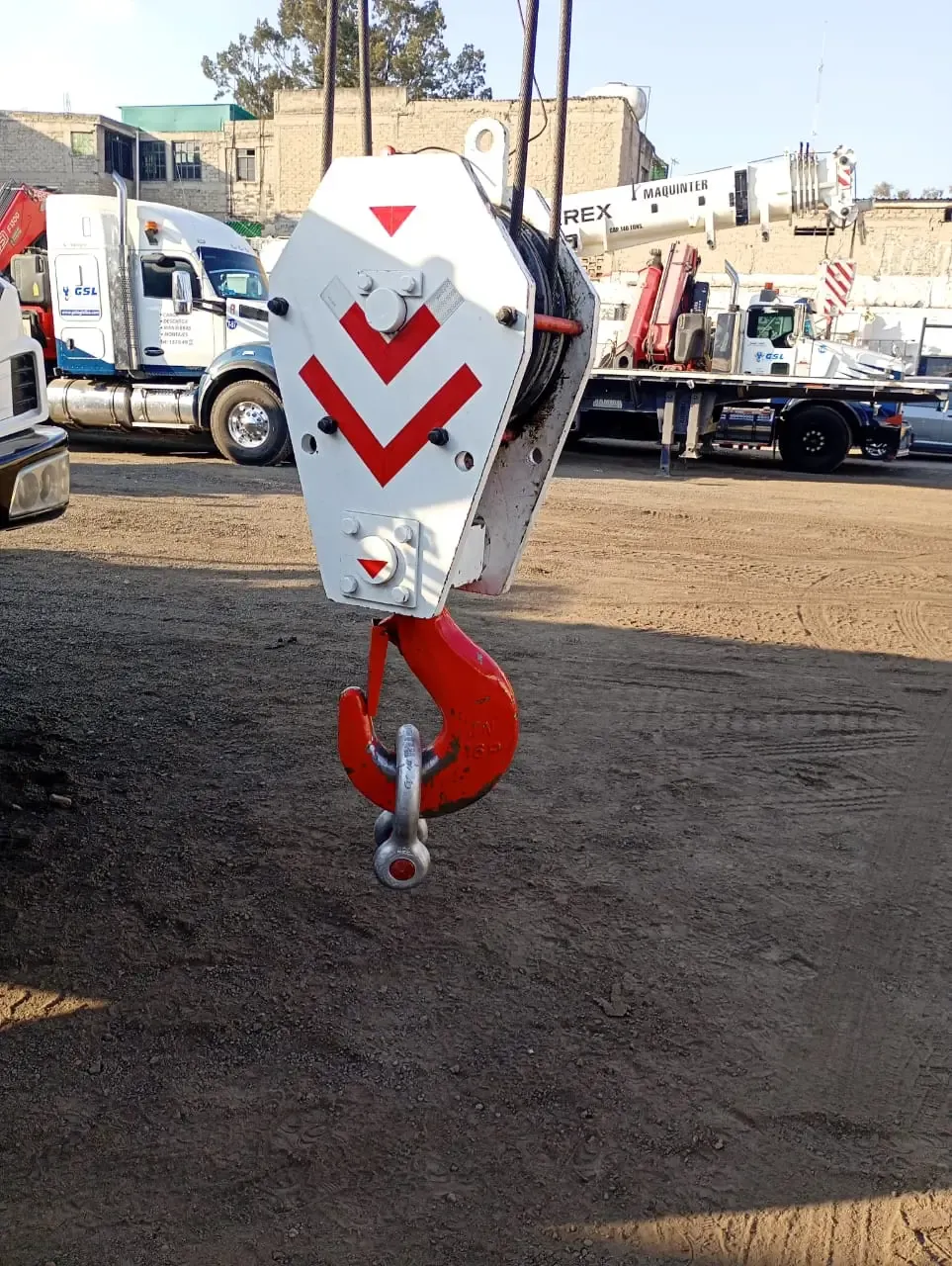 High-capacity gantry crane lifting cargo containers at a port terminal.