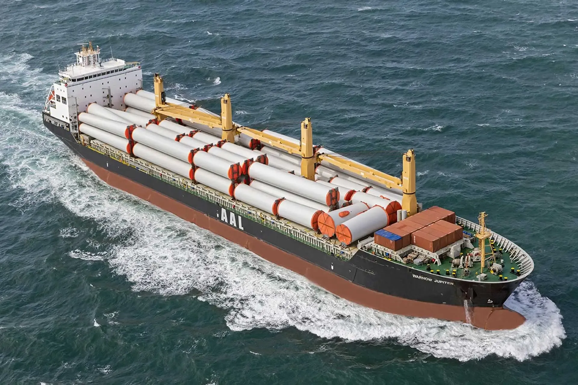 Cargo ship transporting large industrial pieces outside of containers.